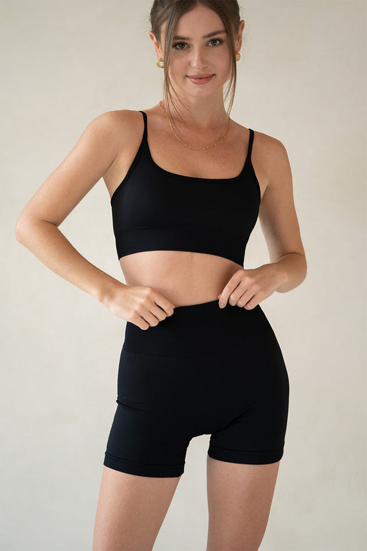 Model wearing Horizon workout set from Aurelia Raw showcasing high-waisted shorts and strappy sports bra