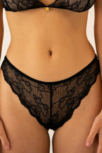 Close-up of Le Petit lace panties from Aurelia Raw with floral lace pattern and scalloped edges