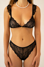 Medium front view of Le Petit black lace lingerie set with scalloped detailing and gold charm accent on the bra
