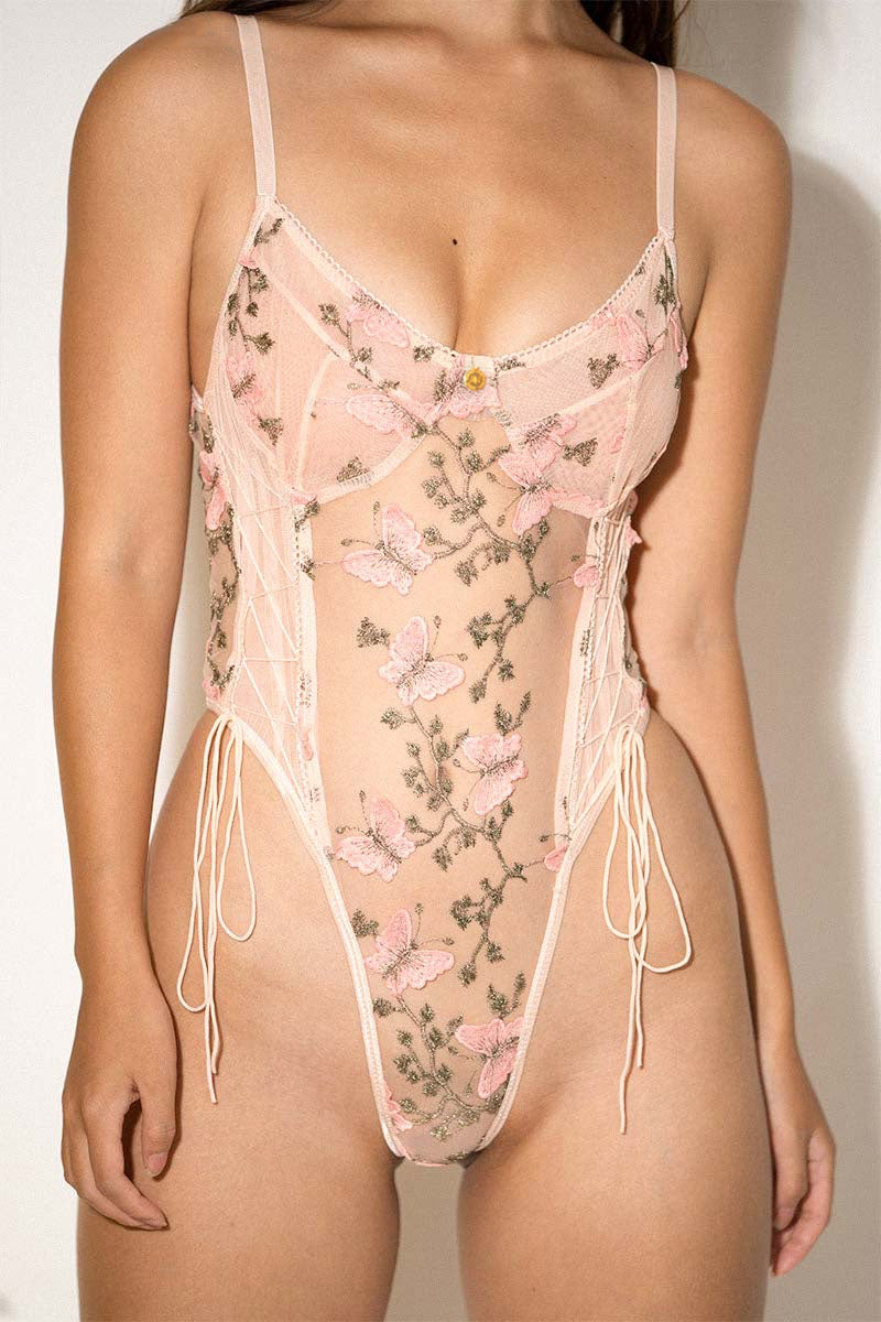 Detailed front view of Aurelia Raw Violante One-Piece showing floral embroidery and corset side ties