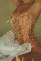 Model wearing Aurelia Raw Violante One-Piece close-up showing embroidered butterflies and floral mesh