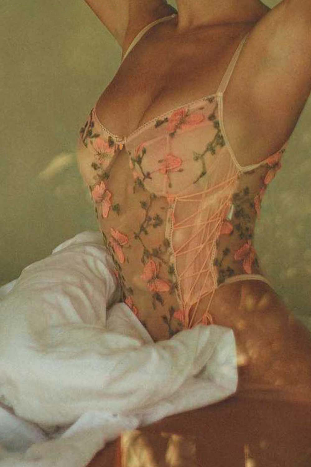 Model wearing Aurelia Raw Violante One-Piece close-up showing embroidered butterflies and floral mesh
